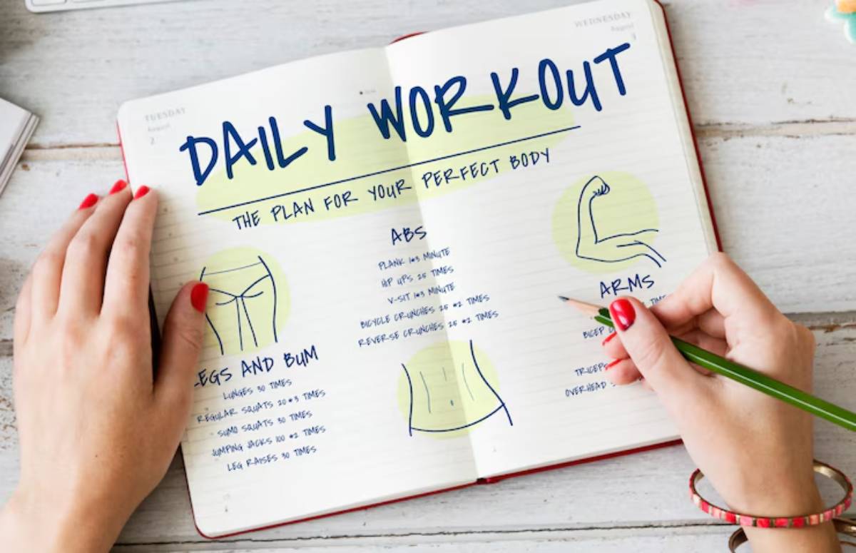 Handwriting a fitness plan in a notebook, detailing exercises for legs, abs, and arms with doodles for each section.