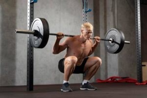 Powerlifter doing pre-workout mobility work before barbell training